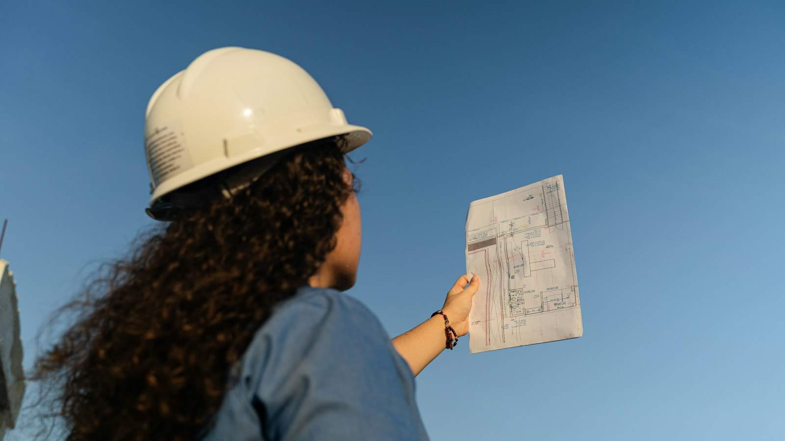 Surveyor checking building plans